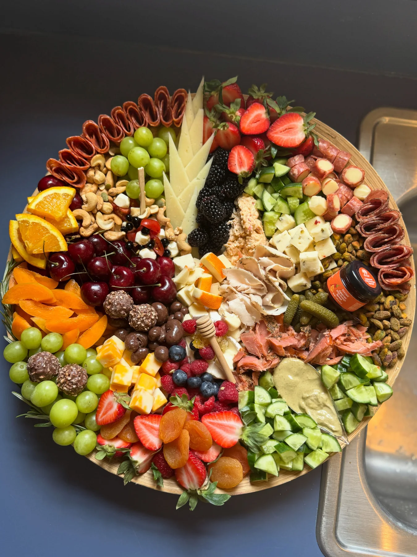 Seasonal charcuterie platter with fruit, cheese, and savory bites